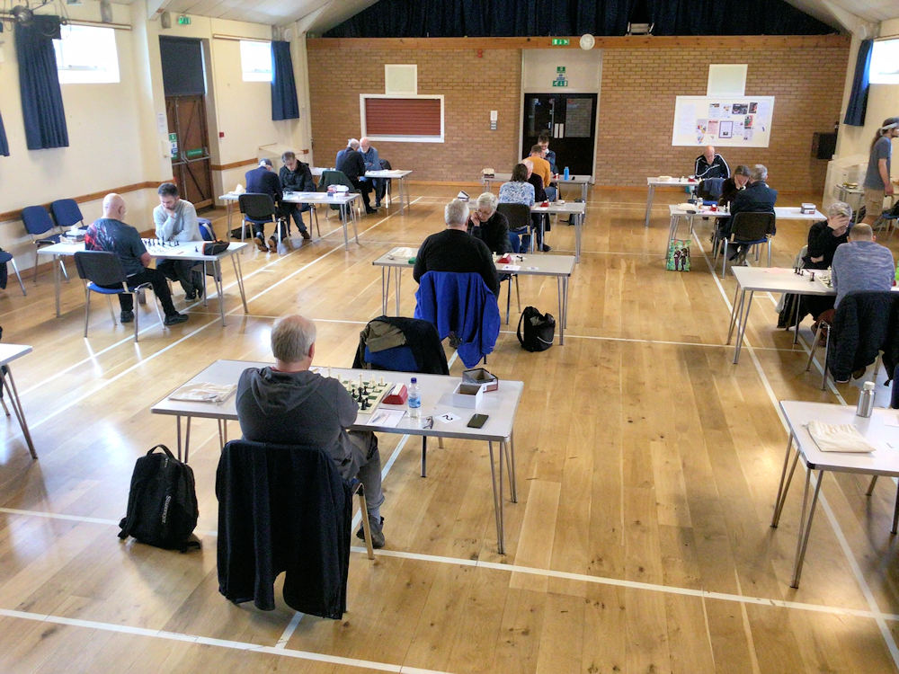 Rows of chess players in a hall